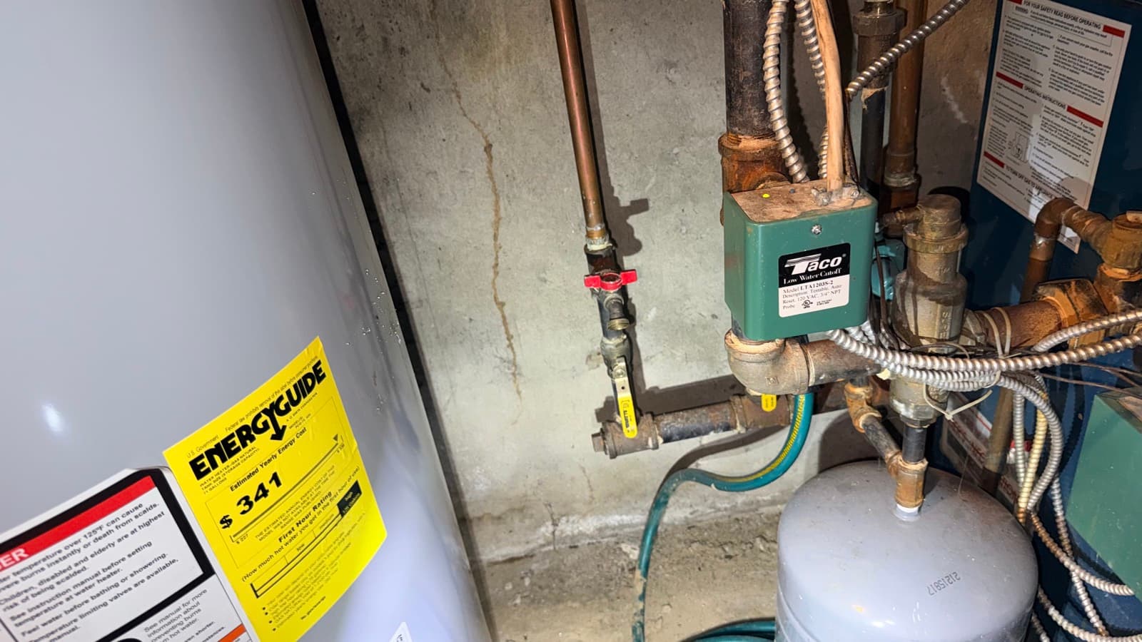 Moisture-damaged utility room with boiler and water heater before mold remediation — Suffolk County NY
